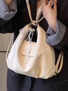 Chic beige lychee leather tote backpack featuring a delicate lace pearl bow accessory