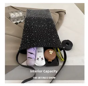 Top view of large capacity black rhinestone bucket bag showing interior essentials