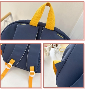 Detail view of navy blue backpack featuring yellow straps and white adjustable buckles