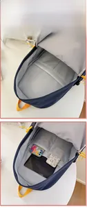 Internal view of blue backpack showing storage pockets for phone and notebooks