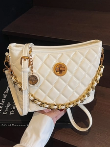 White quilted bucket bag with gold chain and circular swivel lock in elegant setting