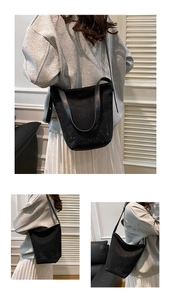 Detail of black bucket bag with sparkling rhinestone gradient and leather strap
