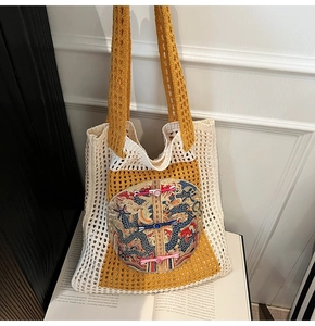 Close-up of knit tote bag featuring Chinese dragon embroidery and traditional frog fasteners