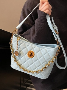Quilted sky blue bucket bag with gold chain strap and metallic clasp closure