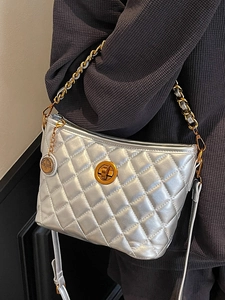 Quilted silver metallic bucket bag with gold chain strap and stylish crossbody design
