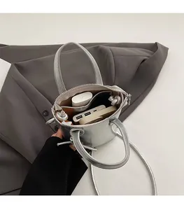 Inside view of silver bucket bag showing ample space for earphones and power bank