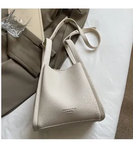 Close-up of cream white lychee pattern leather tote bag with soft texture and shoulder strap