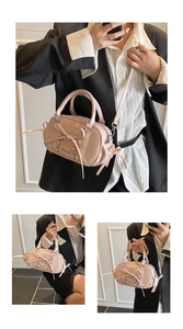 Macro shot of light pink Boston bag featuring decorative bow ties and smooth faux leather
