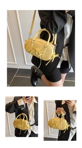 Detailed views of butter yellow Boston bag with decorative bow ties and crossbody strap