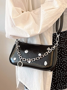 Chic black glossy shoulder bag with silver chain and metal heart studs for women