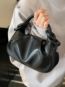 Minimalist black pleated cloud bag with a chunky knotted handle and AMICI & BAG logo