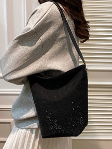 Large black suede bucket bag with gradient rhinestone decor and adjustable shoulder strap
