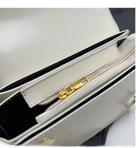 Detail of high-quality smooth golden zipper and inner pocket on the cream leather bag