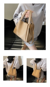 Detail view of camel lychee pattern leather tote bag with fine gold lettering and dual handles