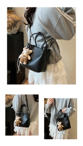 Close-up of black litchi pattern leather bucket bag with cute plush bear charm detail
