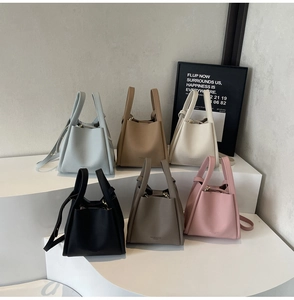 Multiple colors of lychee grain bucket bags shown with adjustable straps and handles