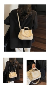 Detailed close-up of cream lychee leather bucket bag with metal handle and decorative chain