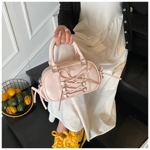 Pink patent leather Boston bag featuring ballet-style ribbons and a sweet bow detail