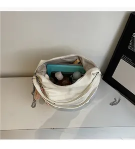Top view of open white faux leather tote showing spacious interior capacity for daily items