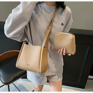 Detail of light brown lychee grain leather bucket bag set with matching inner pouch