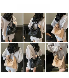 Multiple views of large soft leather tote bag with chain detail and plush bear charm