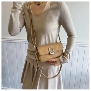 Detail of camel lychee pattern leather shoulder bag with a square silver metal clasp