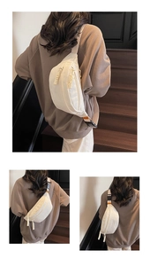 Detailed views of a white minimalist chest bag with orange woven label and braided zippers