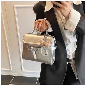 Silver mini square bag with metallic texture, decorative bow and pearl charm detail