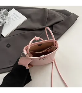 Detailed interior of the light pink mini crossbody bag with magnetic closure and inner pocket