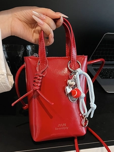 Chic red mini tote bag with glossy leather finish and heart-tennis racket charm detail