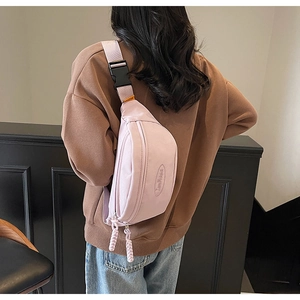 Detail view of the light purple nylon chest bag showing the adjustable strap and buckle