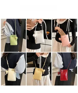 Mini crossbody phone bags in vibrant colors featuring elephant charms and braided straps