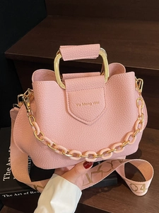 Pink lychee texture bucket bag with gold metal handle and jacquard fabric strap