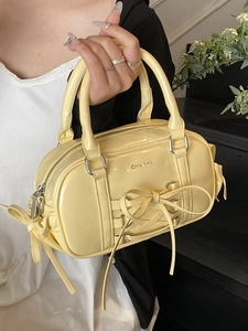 Pale yellow patent leather Boston bag with ballet ribbon bow and top handles