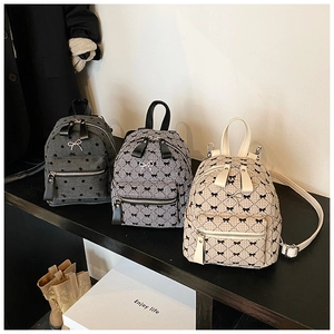 Close-up of mini bow backpacks in polka dot, houndstooth, and beige plaid patterns