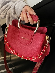 Red lychee grain leather bucket bag with gold U-shaped handle and fashion chain strap