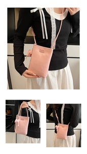 Pink leather crossbody phone bag featuring an embossed letter m and a cute elephant charm