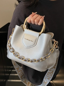 Silver lychee pattern bucket bag with round metal handle and wide woven shoulder strap