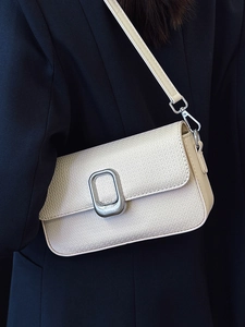Minimalist cream white textured leather crossbody bag with silver oval buckle detail