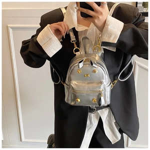 Detail of silver mini backpack with cat ears and metallic golden kitten hardware