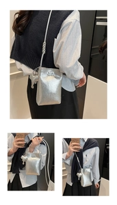Silver metallic crossbody phone bag with m logo and cute elephant charm detail