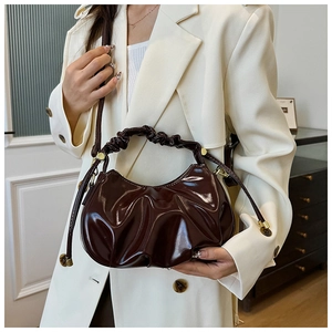 Detailed view of dark brown oil wax leather bag with elegant pleated cloud design texture