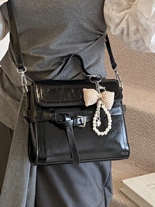 Minimalist French style black glossy leather satchel with pearl bow charm and shoulder strap
