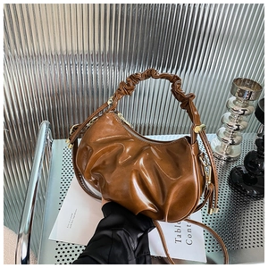 Detail showing brown ruched cloud bag with oil wax finish and gold metal zipper
