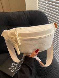 Minimalist beige canvas crossbody fanny pack with embroidered logo and adjustable strap