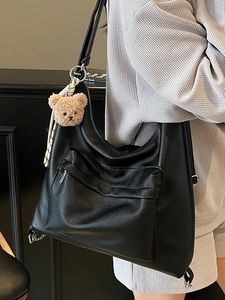 Minimalist large black pebbled leather tote bag with brown bear charm for women