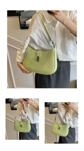 Detail view of avocado green minimalist leather shoulder bag with bronze metal buckle