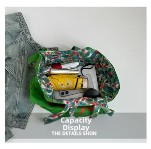Top view of large green canvas tote bag showing spacious interior with floral lining