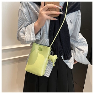 Lime green mini crossbody phone bag with 3D m logo and cute elephant charm