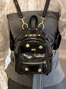 Mini black faux leather backpack with gold puppy charms and studs for women